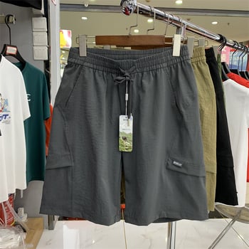 Férfi sportos mindennapi nadrág zsebekkel, lélegző poliészter, mikro-elasticitás, középmagas derék, 3/4 hossz