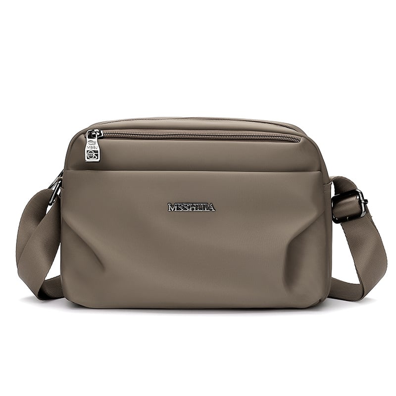 Ženska crossbody torba, tekstilni materijal, urban minimalistički stil, horizontalni kvadratni oblik, zatvarač, džep za telefon
