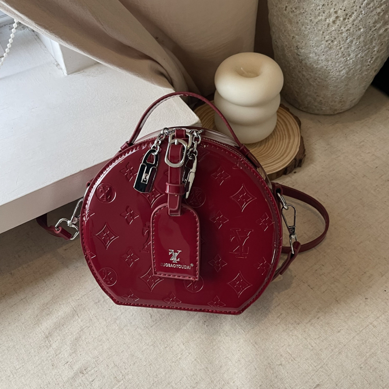 Ženska kružna crossbody torba — gradski minimalistički stil, PU materijal, zatvarač, džep za telefon