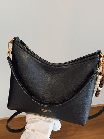 Ženska crossbody bucket torba, PU materijal, platno podstava, vodoravni kvadratni oblik, zatvaranje na zip, dvostruke naramenice