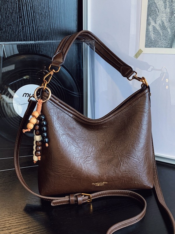 Ženska crossbody bucket torba, PU materijal, platno podstava, vodoravni kvadratni oblik, zatvaranje na zip, dvostruke naramenice