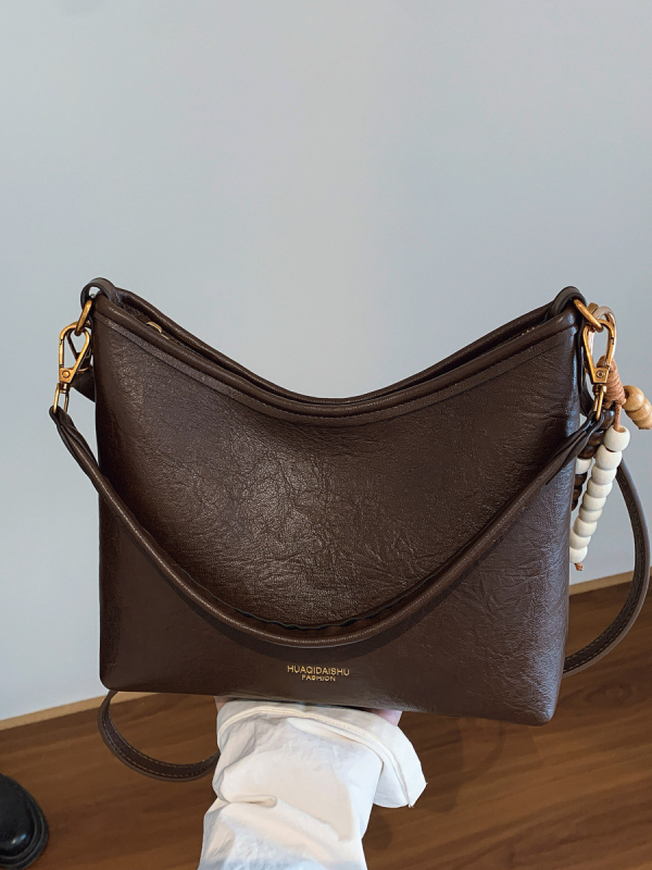Ženska crossbody bucket torba, PU materijal, platno podstava, vodoravni kvadratni oblik, zatvaranje na zip, dvostruke naramenice