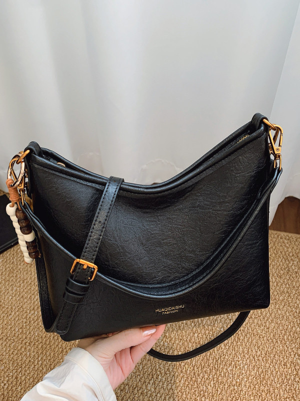 Ženska crossbody bucket torba, PU materijal, platno podstava, vodoravni kvadratni oblik, zatvaranje na zip, dvostruke naramenice