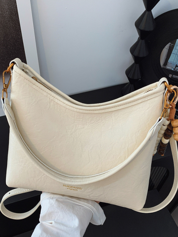 Ženska crossbody bucket torba, PU materijal, platno podstava, vodoravni kvadratni oblik, zatvaranje na zip, dvostruke naramenice