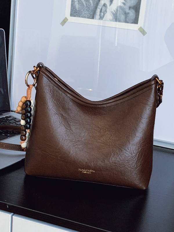 Ženska crossbody bucket torba, PU materijal, platno podstava, vodoravni kvadratni oblik, zatvaranje na zip, dvostruke naramenice