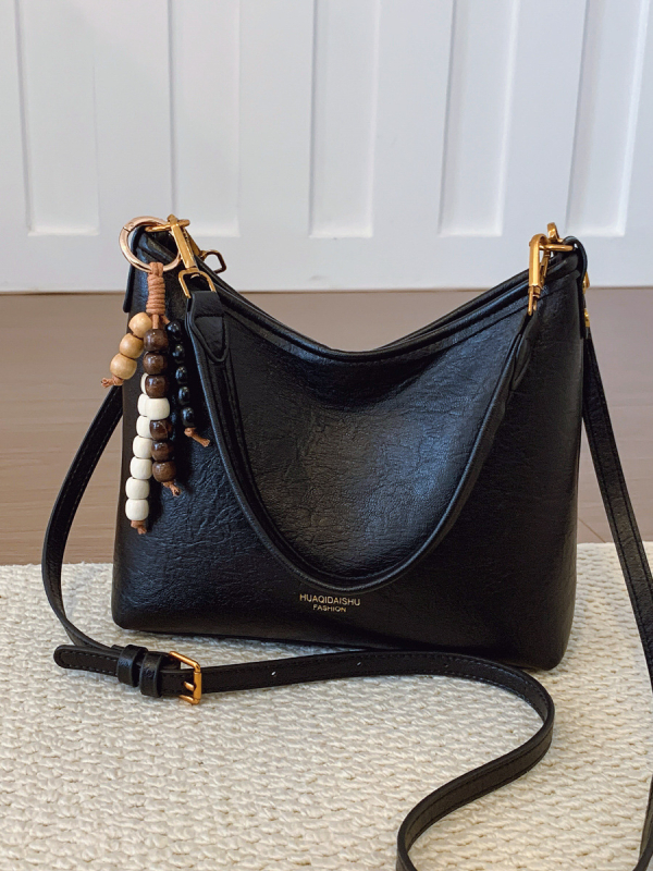 Ženska crossbody bucket torba, PU materijal, platno podstava, vodoravni kvadratni oblik, zatvaranje na zip, dvostruke naramenice