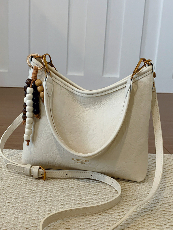 Ženska crossbody bucket torba, PU materijal, platno podstava, vodoravni kvadratni oblik, zatvaranje na zip, dvostruke naramenice