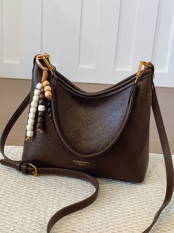 Ženska crossbody bucket torba, PU materijal, platno podstava, vodoravni kvadratni oblik, zatvaranje na zip, dvostruke naramenice