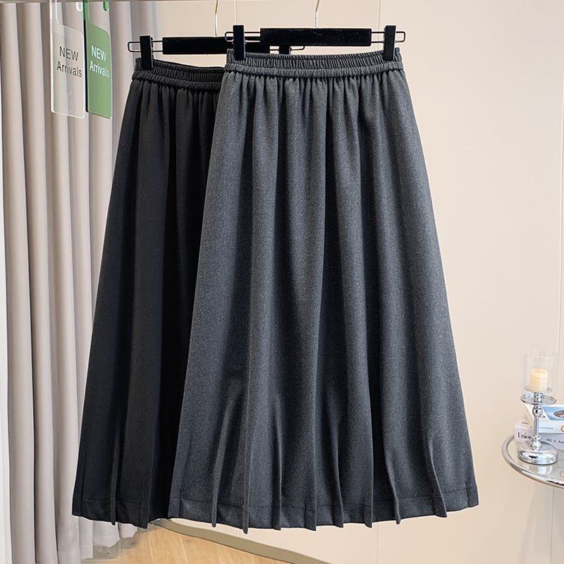 Vunena srednje duga A-linijska suknja s korejskim stilom plisiranog ruba, elastičan pojas i trodimenzionalni kroj; 70–80% pamuka, do 30% elastana.