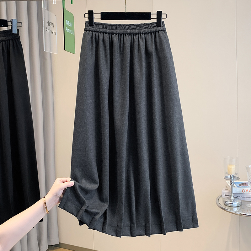 Vunena srednje duga A-linijska suknja s korejskim stilom plisiranog ruba, elastičan pojas i trodimenzionalni kroj; 70–80% pamuka, do 30% elastana.