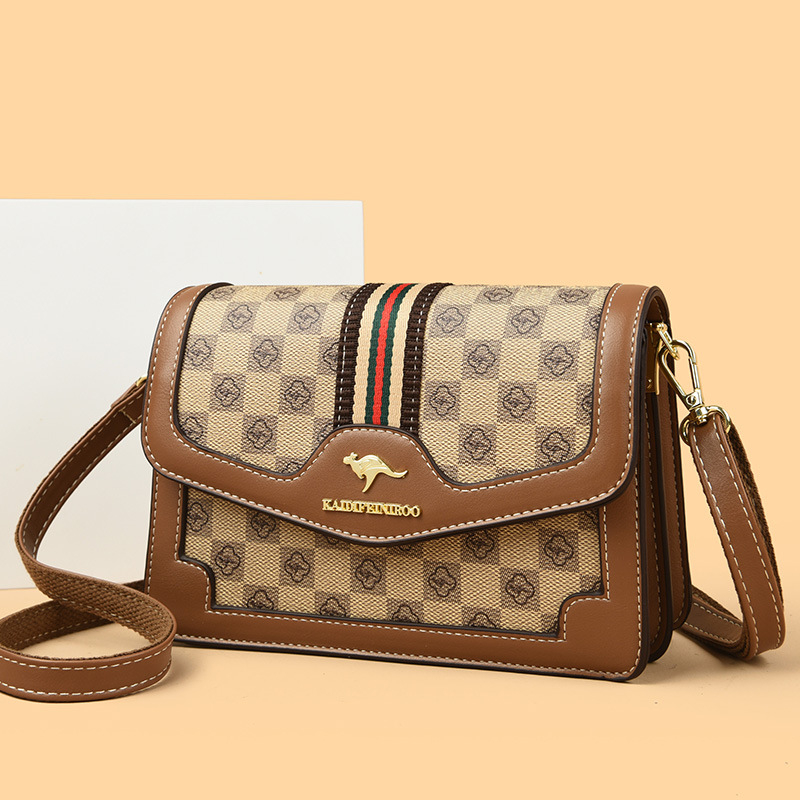 Ženska crossbody torba – mekana sintetička koža, mali kvadratični oblik, zatvaranje poklopcem, unutarnji džepovi sa zipom i džep za dokumente, dvostruke naramenice