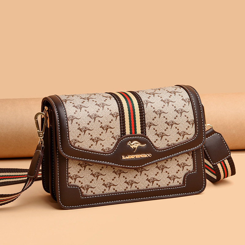 Ženska crossbody torba – mekana sintetička koža, mali kvadratični oblik, zatvaranje poklopcem, unutarnji džepovi sa zipom i džep za dokumente, dvostruke naramenice