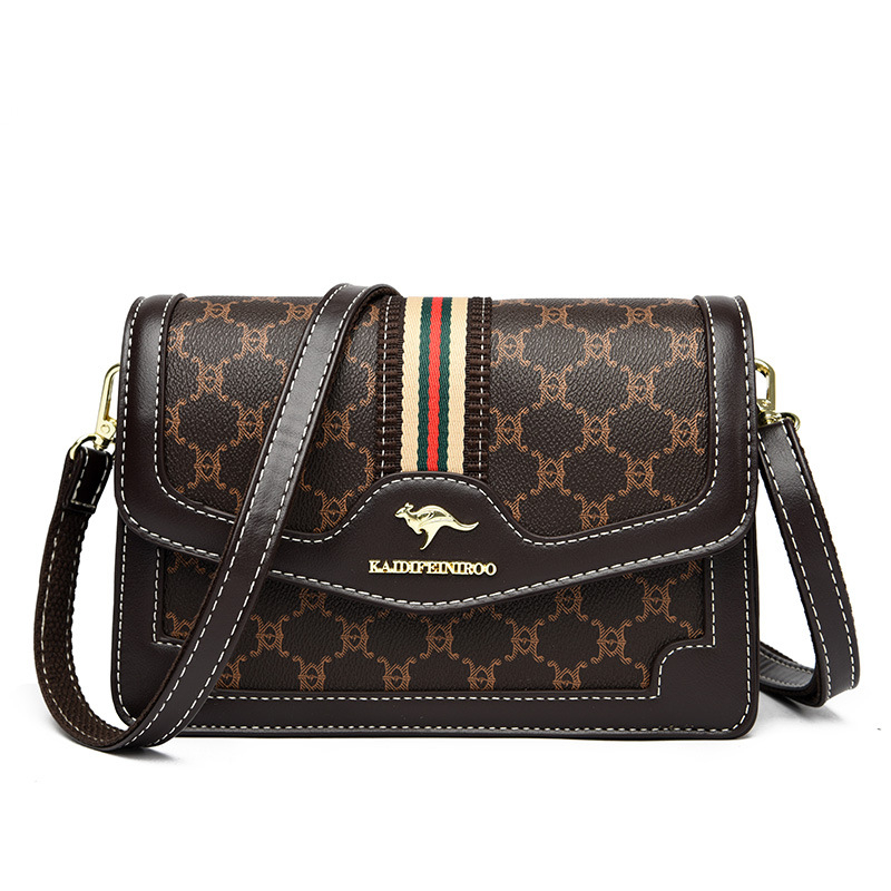 Ženska crossbody torba – mekana sintetička koža, mali kvadratični oblik, zatvaranje poklopcem, unutarnji džepovi sa zipom i džep za dokumente, dvostruke naramenice