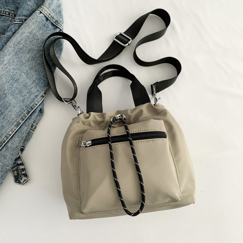 Ženska nylon torba tipa bucket, gradski minimalistički dizajn, oblik košare sa zatvaračem