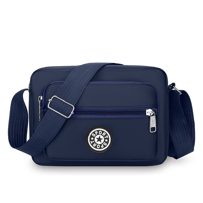 Crossbody torba od Oxford platna, kompaktna kvadratna forma, sa zatvaračem i pretincima za telefon i dokumente