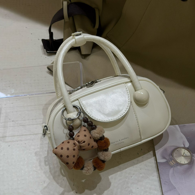 Crossbody torba u urban minimalističkom stilu, PU koža, bowling bag stil, horizontalno pravokutni oblik, zip zatvarač