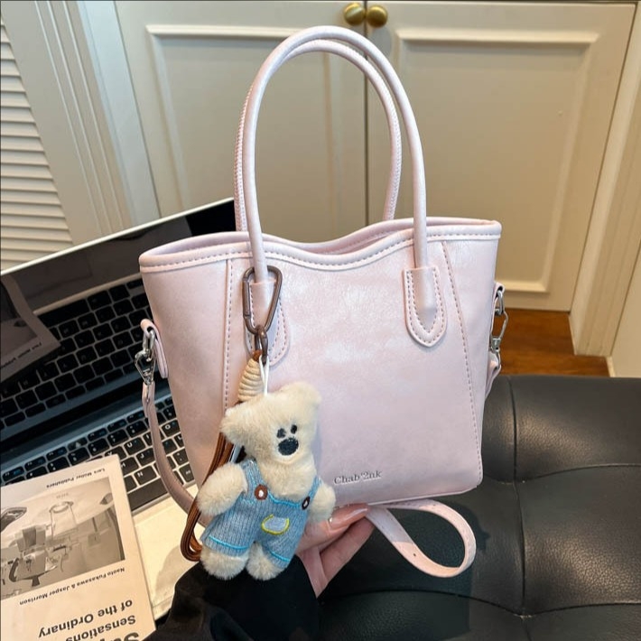 Geantă bucket din PU, stil urban minimalist, închidere magnetică, curea simplă, buzunar pentru telefon, primăvara 2026