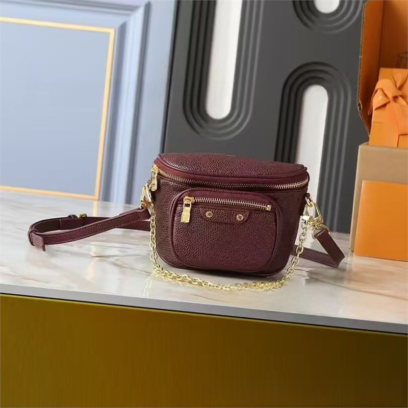 Crossbody torbica od prave kože, okruglog oblika, zatvaranje zipom, dvostruki remen