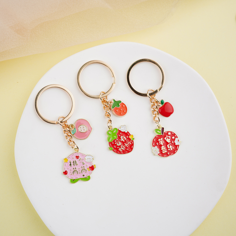 Fém kulcstartó medál – gyümölcs ihletésű szöveges dizájn és aranyos lányos karikatúra, táska kiegészítő, ajándék