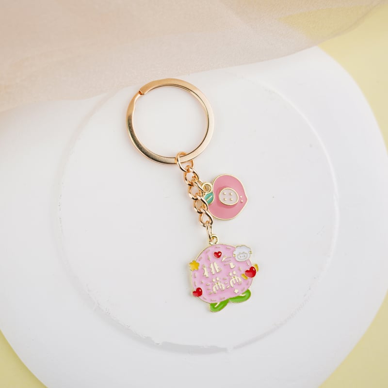 Fém kulcstartó medál – gyümölcs ihletésű szöveges dizájn és aranyos lányos karikatúra, táska kiegészítő, ajándék