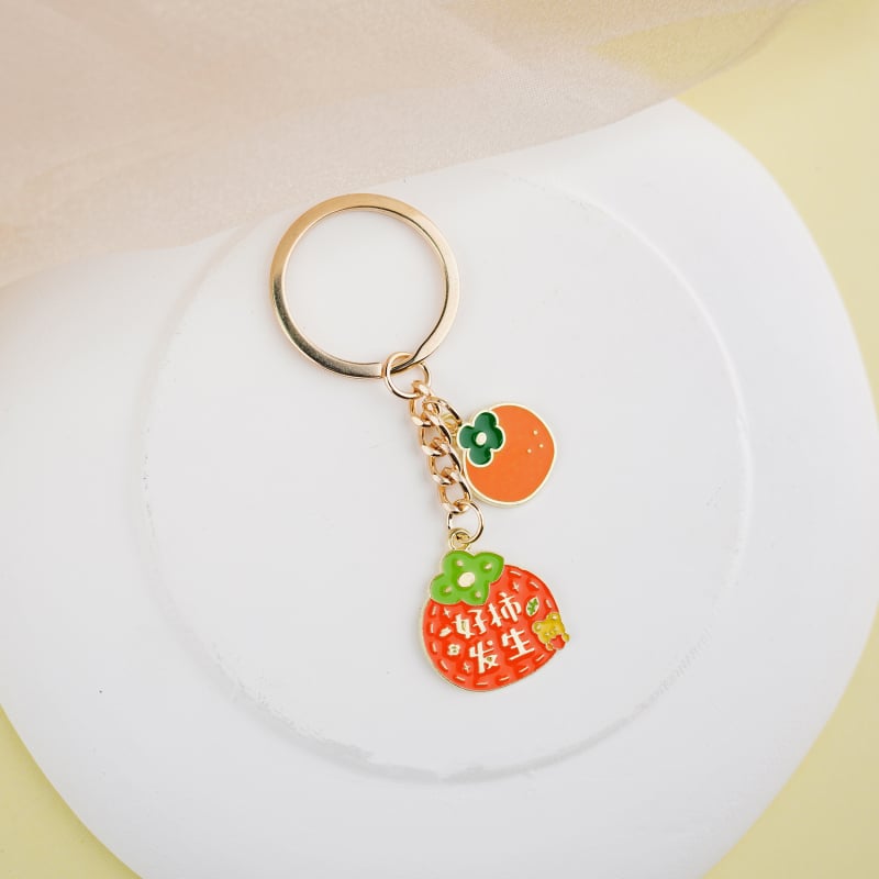 Fém kulcstartó medál – gyümölcs ihletésű szöveges dizájn és aranyos lányos karikatúra, táska kiegészítő, ajándék