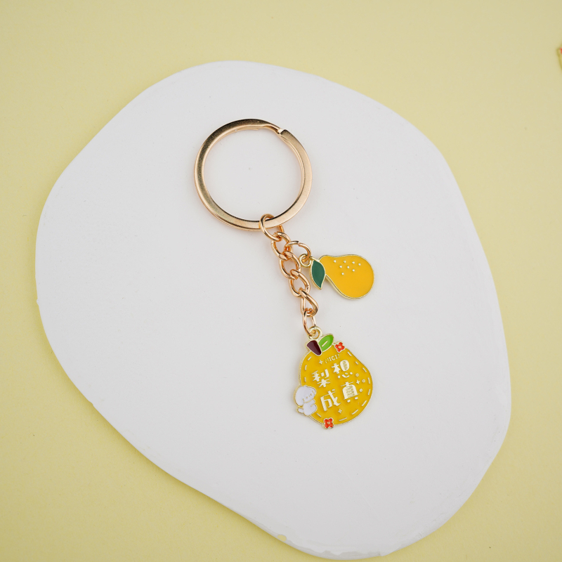Fém kulcstartó medál – gyümölcs ihletésű szöveges dizájn és aranyos lányos karikatúra, táska kiegészítő, ajándék
