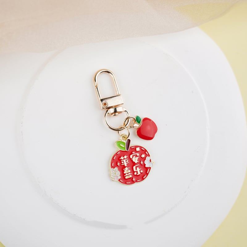 Fém kulcstartó medál – gyümölcs ihletésű szöveges dizájn és aranyos lányos karikatúra, táska kiegészítő, ajándék