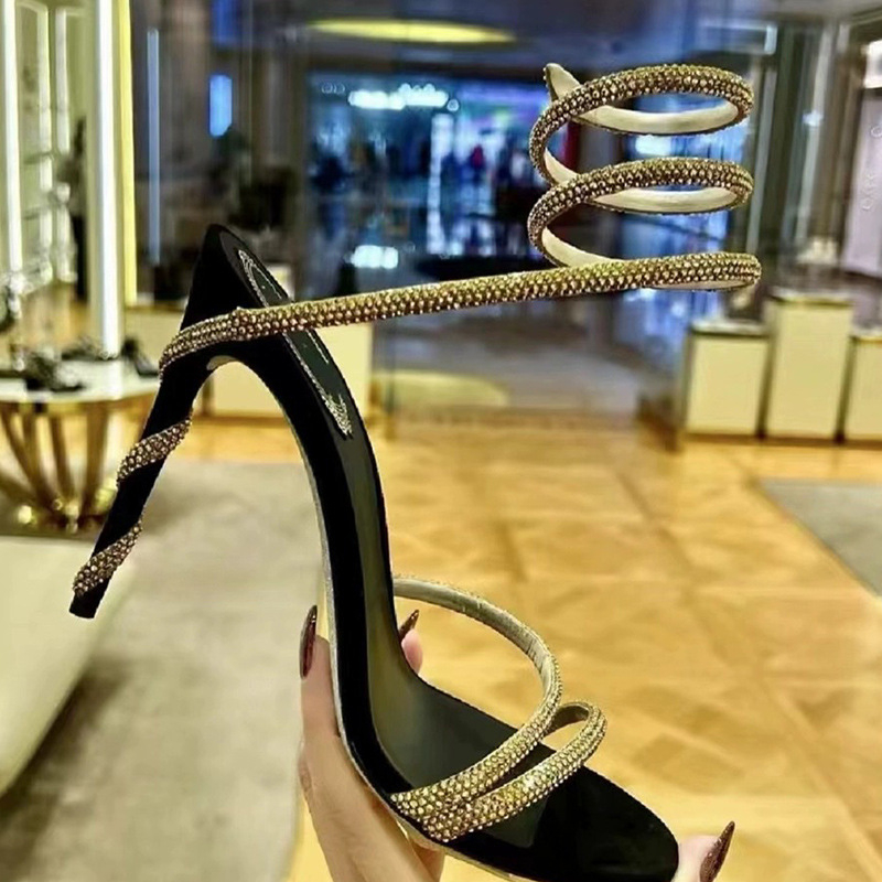 Ženske sandale s visokim potpeticama ukrašene kristalima i motivom zmije, otvoreni prsti, tanki remeni, stiletto potpetica, ljeto 2024