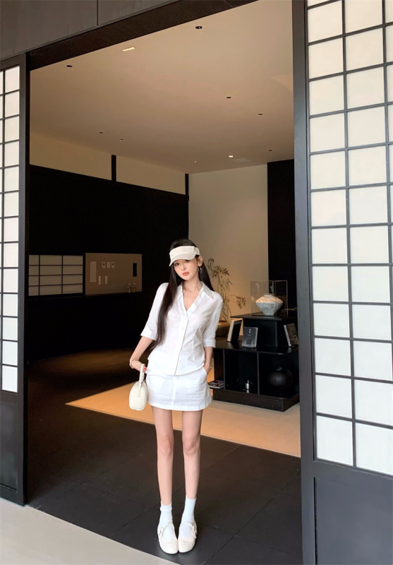 Двоен комплект: бяла риза с V-образно деколте и тясна талия, дълги ръкави, къса пола с висока талия.