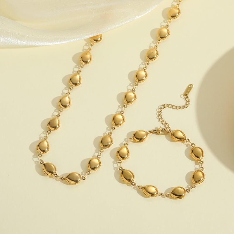 Ženski set nakita od titan čelika: ogrlica s dutom kapljom i narukvica s križem i školjkom