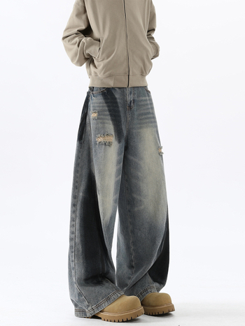 Férfi farmernadrág amerikai stílusban tintás graffiti mintával, kopásokkal, repedésekkel, széles szabású, őszi viselet