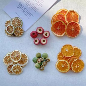 DIY set svijeće: ploške limuna i naranče, suho cvijeće, ispod staklene kupole