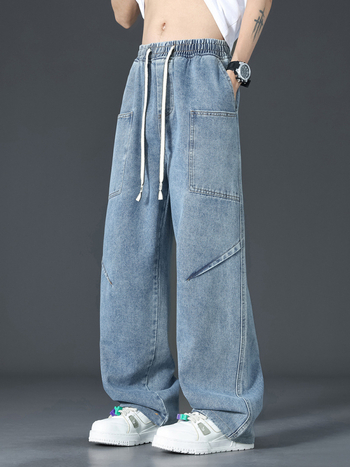 Muške traperice u američkom retro stilu s dekonstruiranim krojem, pojas s vezicom i elastikim, mekani isprani denim, više džepova, lagano šire nogavice za ljeto.