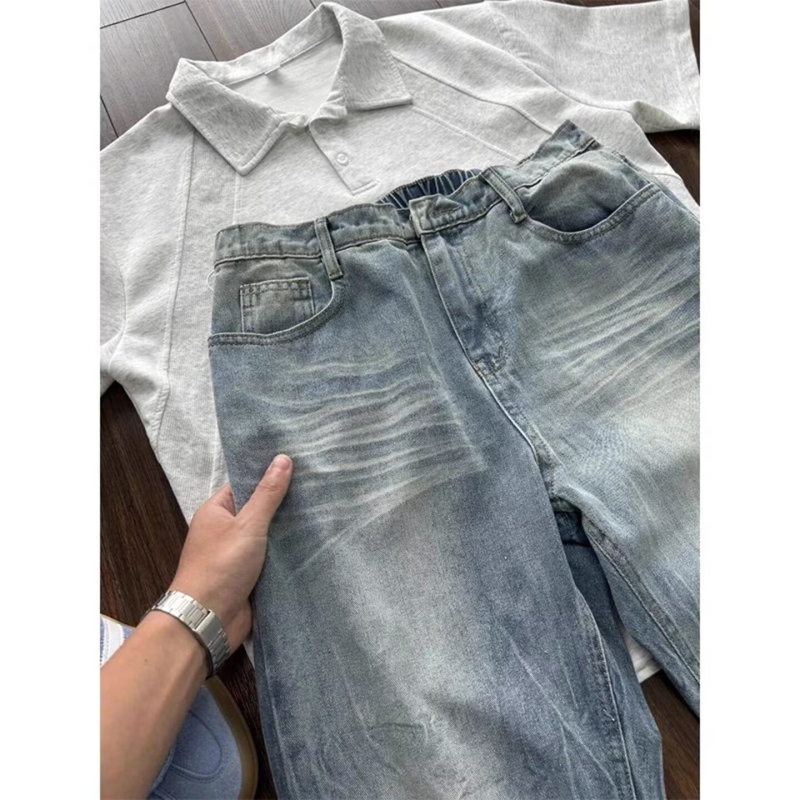 Muške traperice Cleanfit u američkom street stilu, isprani denim s oštećenjima, crno-sive, ravnog kroja s blagim širim donjim dijelom