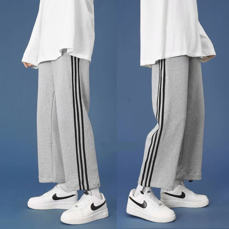 Muške casual hlače za proljeće i jesen, hongkonški i korejski stil, svestrane, s vezanjem, opuštena silueta, uspravni kroj, široke nogavice, tri crte, sportska 3/4 dužina.