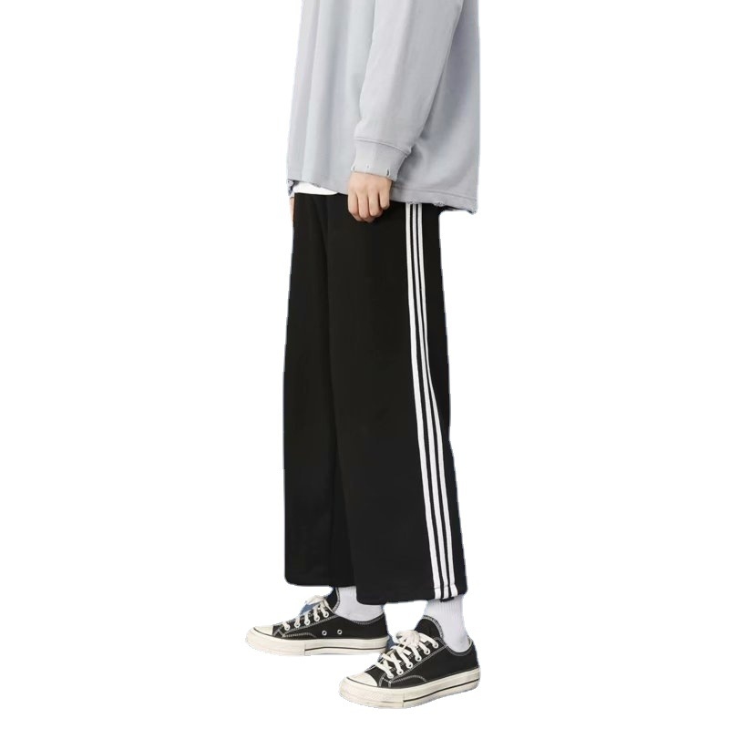 Muške casual hlače za proljeće i jesen, hongkonški i korejski stil, svestrane, s vezanjem, opuštena silueta, uspravni kroj, široke nogavice, tri crte, sportska 3/4 dužina.