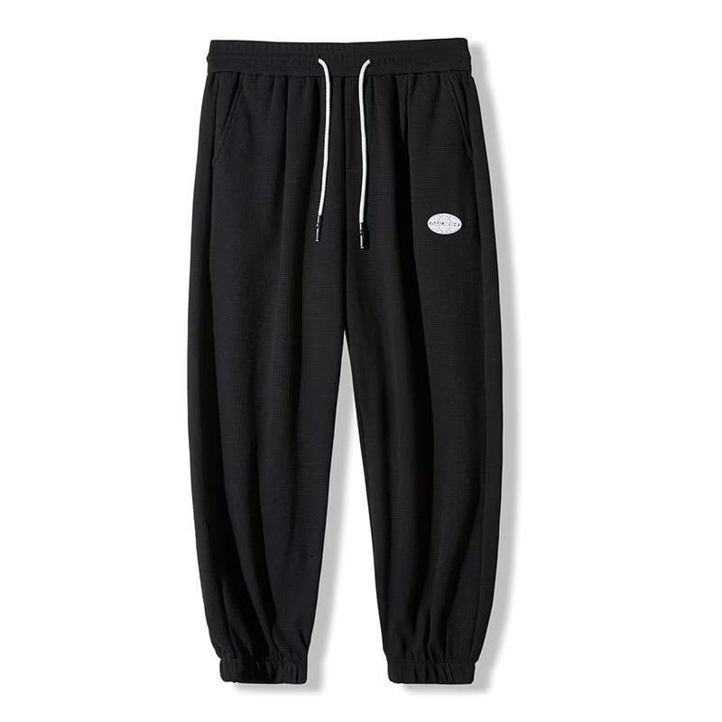 Muške hlače s flecom iznutra i vafl uzorkom, kratka duljina, slobodan kroj, sportski stil.