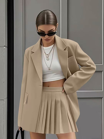 Ženski kostim s plisiranom suknjom – casual moda (proljeće 2025)