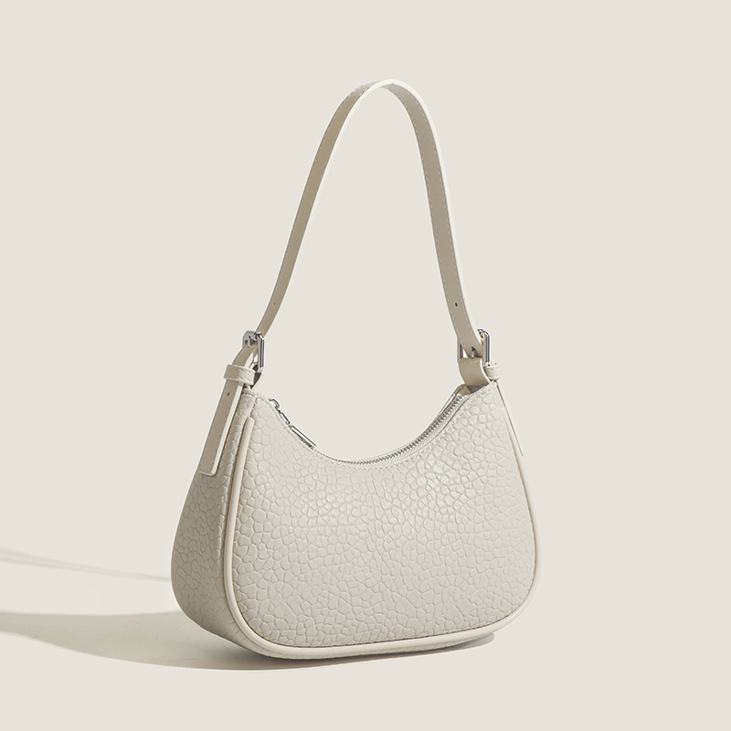 2026 Nova modna minimalistička torba za podlakticu s dojmljivim dojmom vrhunske kvalitete, bijela baguette torba, svestrana za rame ili crossbody.