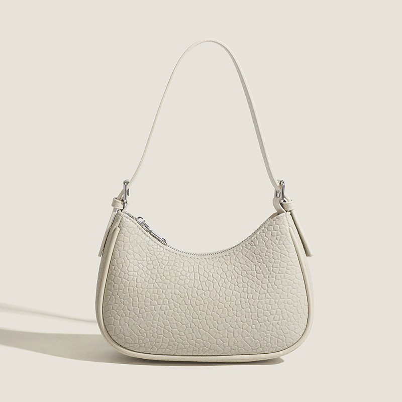 2026 Nova modna minimalistička torba za podlakticu s dojmljivim dojmom vrhunske kvalitete, bijela baguette torba, svestrana za rame ili crossbody.