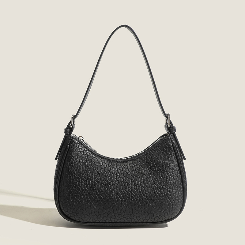 2026 Nova modna minimalistička torba za podlakticu s dojmljivim dojmom vrhunske kvalitete, bijela baguette torba, svestrana za rame ili crossbody.