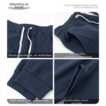 Teške jogger hlače od twill tkanine u tamnoplavojoj boji, širokog kroja, duge, s manžetom pri gležnjevima, sportsko- casual