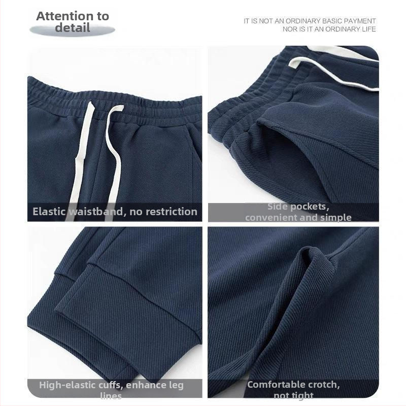 Teške jogger hlače od twill tkanine u tamnoplavojoj boji, širokog kroja, duge, s manžetom pri gležnjevima, sportsko- casual