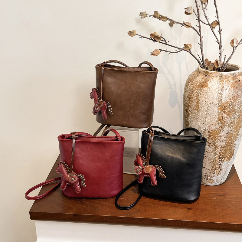 Ženska bucket torba, proljeće 2026, retro stil, teksturirana površina, elegantna i svestrana preko ramena ili crossbody