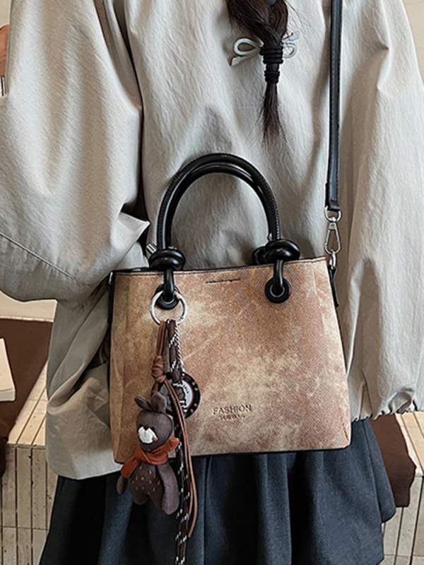 Mala crossbody torba tipa bucket sa zatvaračem, gradski minimalistički dizajn, retro inspiracija