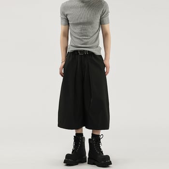 Egyszínű, széles lábú nadrág plisírozott, drapírozott sziluettel, fél rugalmas derekú, cropped hossz, uniszex casual nadrág.
