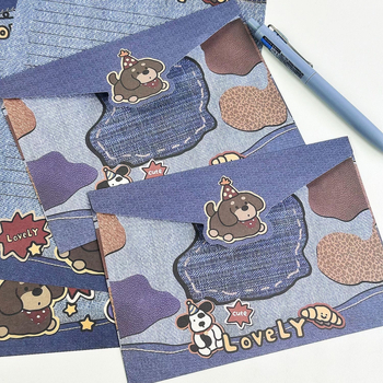 Set omotnica i papir za pisanje s crtani lutkom u denim boji — kreativni poklon za uspomenu