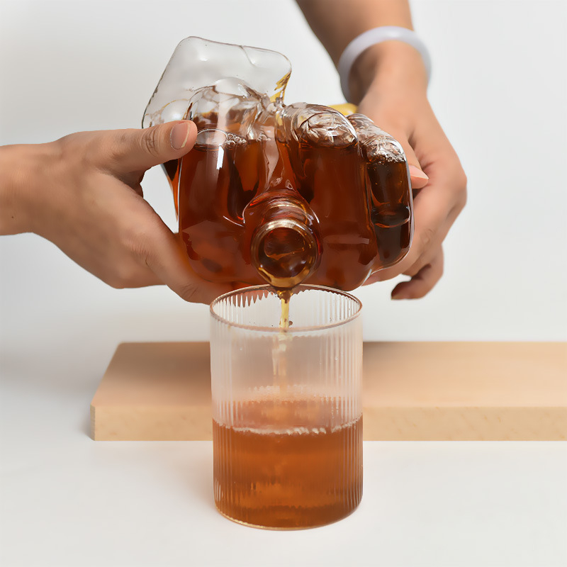 Decantor de sticlă sigilat, în formă de deget mijlociu, pentru whisky