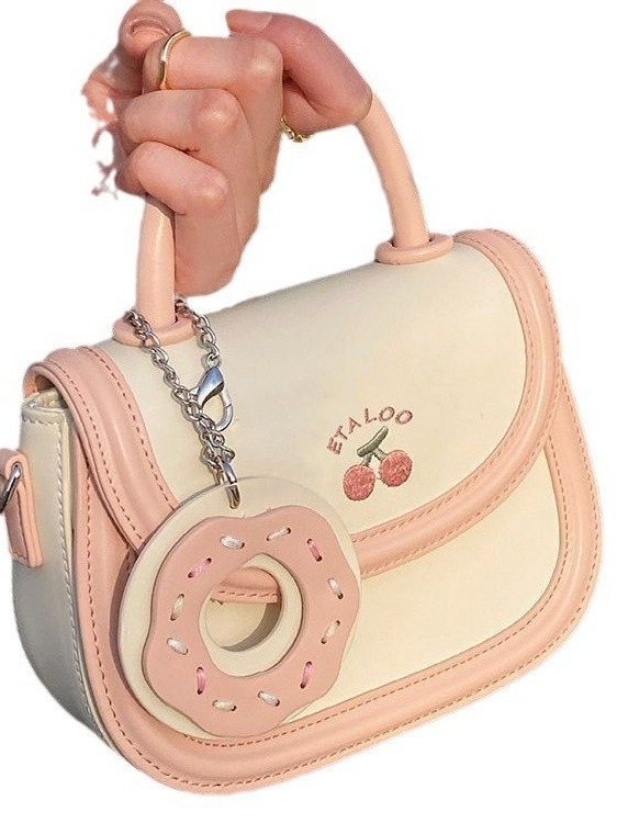 Mala sedlasta torbica biscuit off-white boje, japanskog stila, s ručkom, remenom i crossbody nošenjem, za žene, proljeće–ljeto.