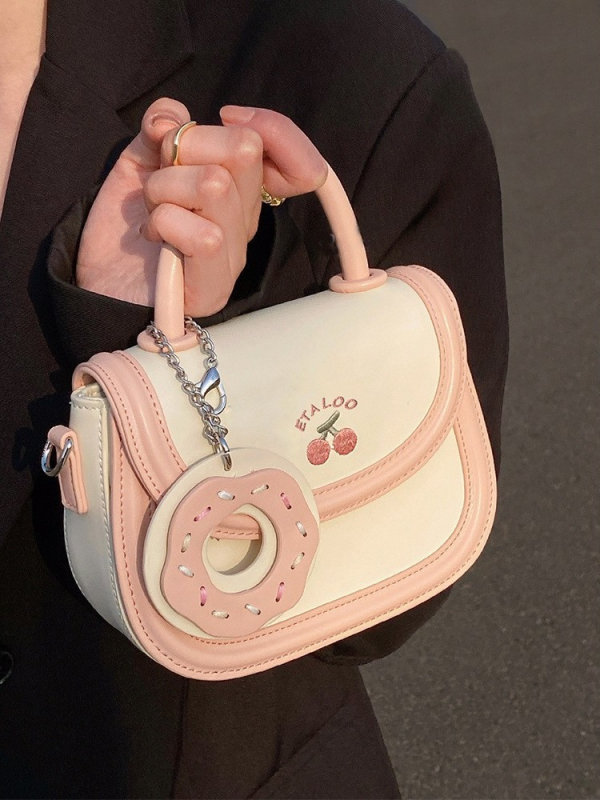 Mala sedlasta torbica biscuit off-white boje, japanskog stila, s ručkom, remenom i crossbody nošenjem, za žene, proljeće–ljeto.